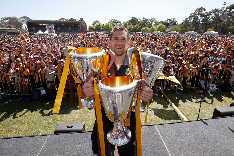 AFL 2015 Media - Hawthorn Family Day Luke Hodge with Hawthorn's past three premiership cups - ${keywords}